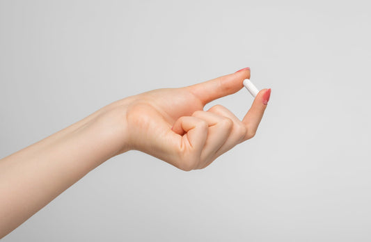 hand holding zinc glycinate capsule increasing testosterone 