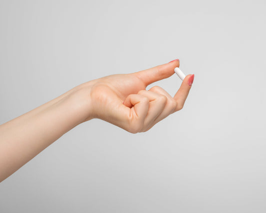hand holding zinc glycinate capsule, supporting testosterone 